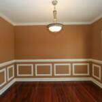 Dining Room with rich hardwood floors, crown molding, chair railing, and picture molding