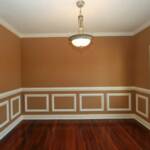 Dining Room with rich hardwood floors, crown molding, chair railing, and picture molding